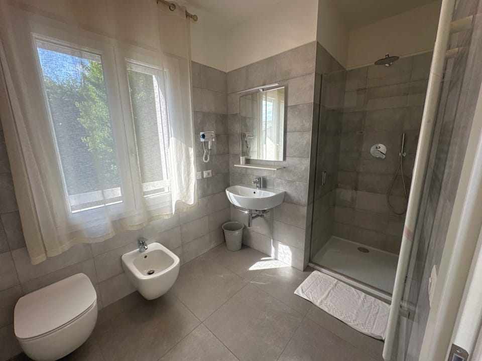 Standard Double Room | Bathroom | Shower, hair dryer, towels, soap