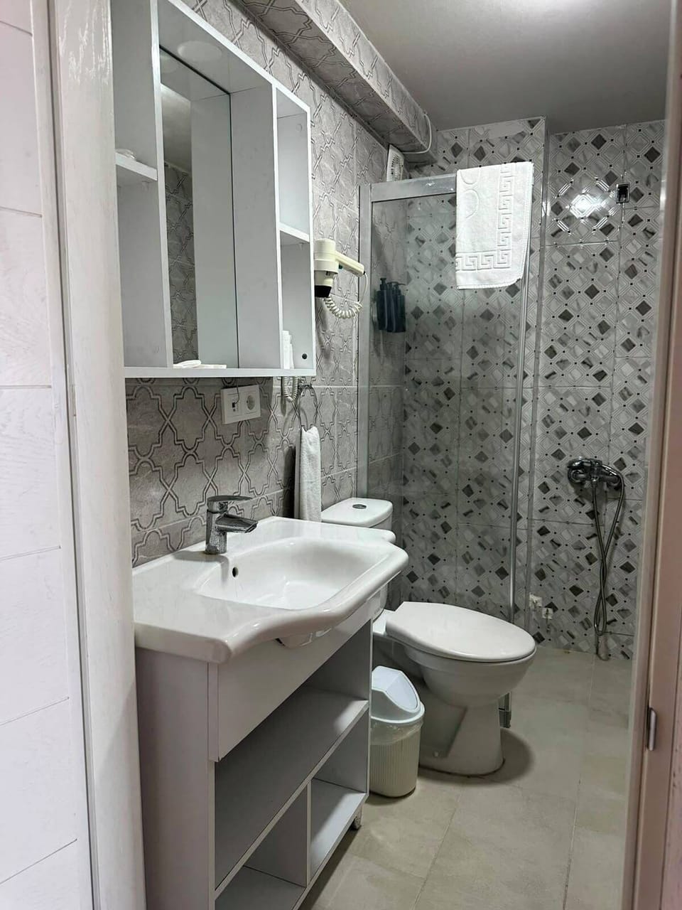 Shower, hair dryer, slippers, towels