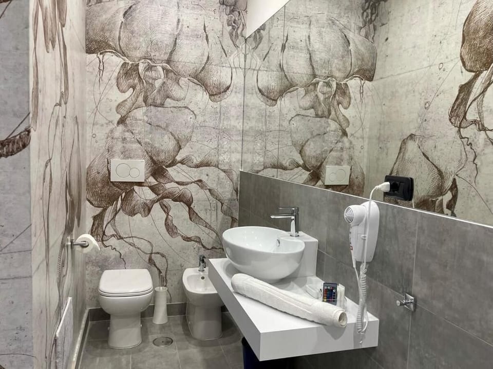 Junior Suite, Balcony, City View | Bathroom | Shower, hair dryer, slippers, towels