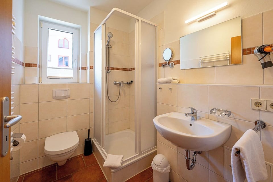 Shower, hair dryer, towels, toilet paper