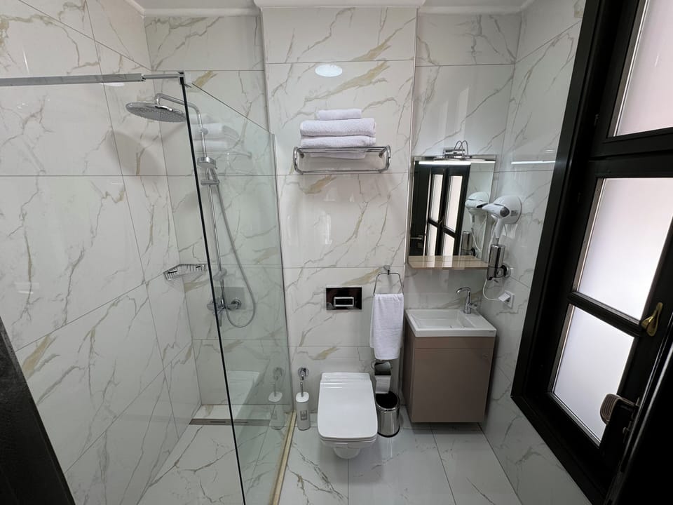 Deluxe Double Room, 1 Double Bed | Bathroom | Shower, hair dryer, slippers, towels