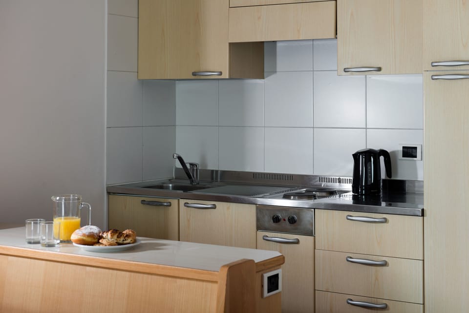 Fridge, stovetop, electric kettle, cookware/dishes/utensils
