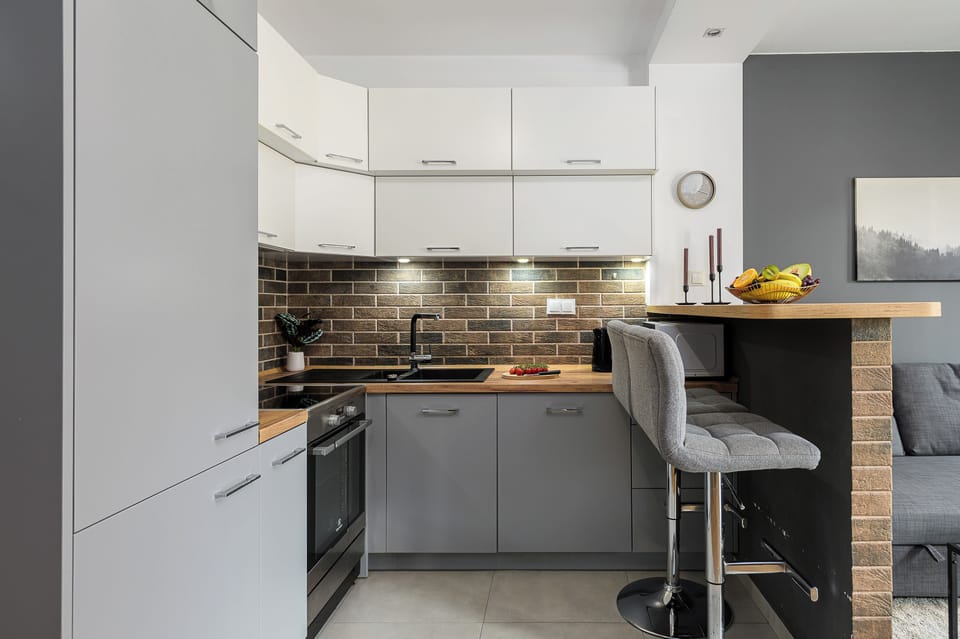 Deluxe Apartment, 2 Bedrooms, Courtyard View | Private kitchen | Electric kettle, highchair, griddle, eco-friendly cleaning products