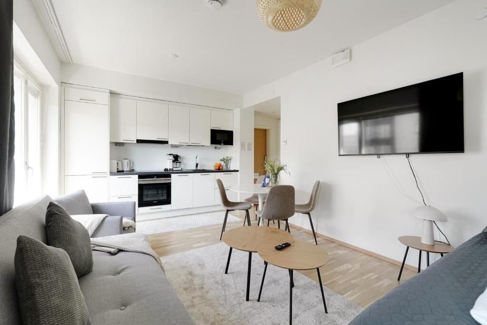 Deluxe Condo, City View | Living area | 55-inch Smart TV with cable channels