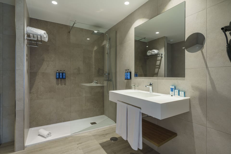 Shower, rainfall showerhead, hair dryer, towels