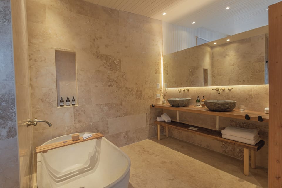 Deluxe Suite | Bathroom | Hair dryer, slippers, towels, soap