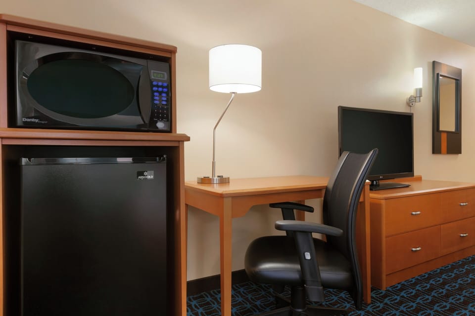 Premium bedding, desk, laptop workspace, blackout drapes