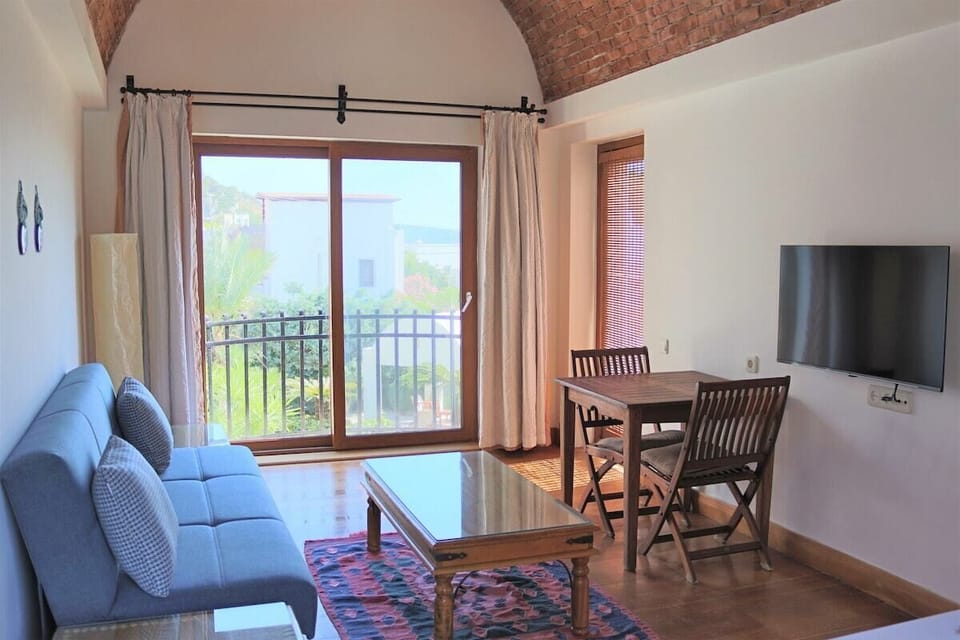 Family Suite, Patio, Sea View | Living area | 32-inch LCD TV with satellite channels