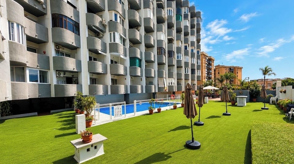 Outdoor pool, open 10:00 AM to 10:00 PM, pool umbrellas