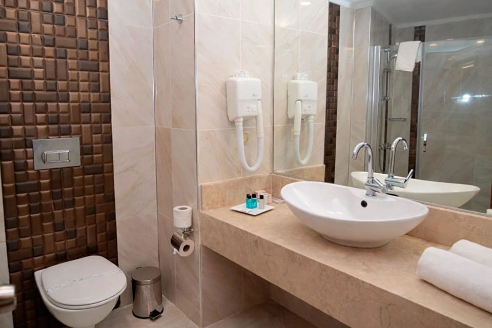 Family Room, 2 Bedrooms, Balcony | Bathroom | Rainfall showerhead, designer toiletries, hair dryer, towels