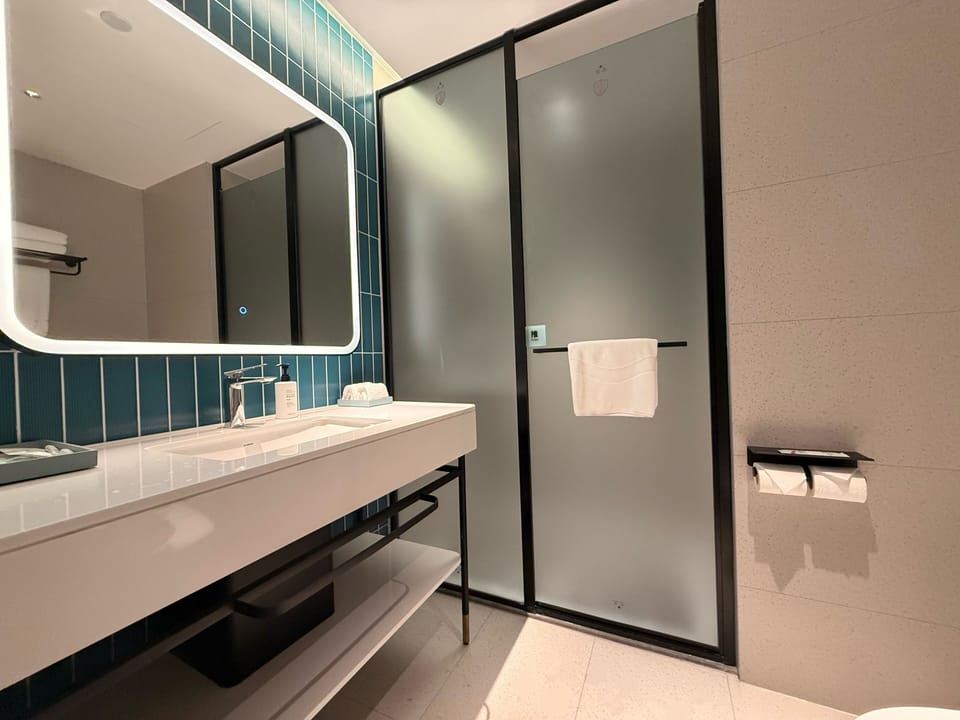 Shower, hair dryer, slippers, towels