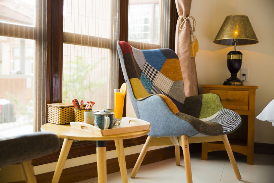 Deluxe Room, Pool View | Free minibar, in-room safe, desk, laptop workspace