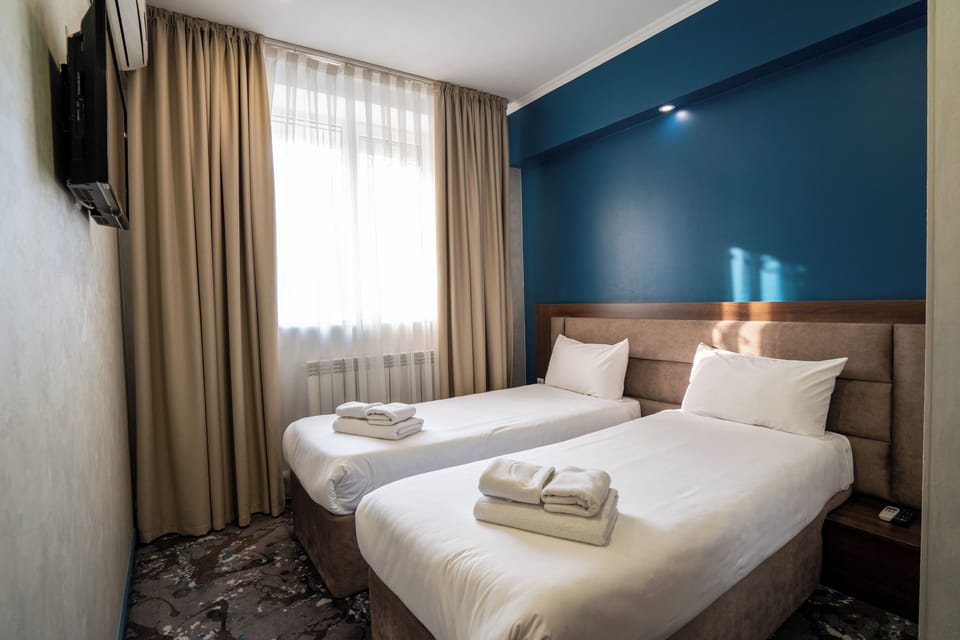 Double or Twin Room, City View | In-room safe, desk, blackout drapes, iron/ironing board