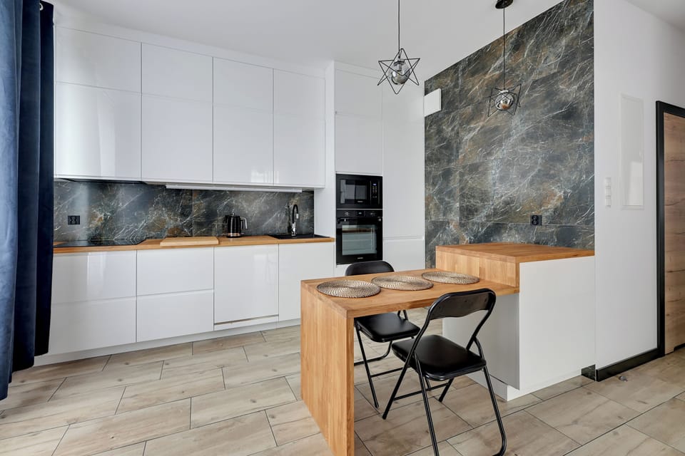 Deluxe Apartment, Balcony, Courtyard View | Private kitchenette | Coffee/tea maker, electric kettle, toaster, highchair