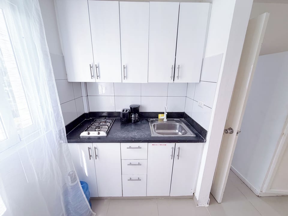 Deluxe Studio, 1 Queen Bed, Pool View | Private kitchen | Coffee/tea maker, fridge, microwave, stovetop