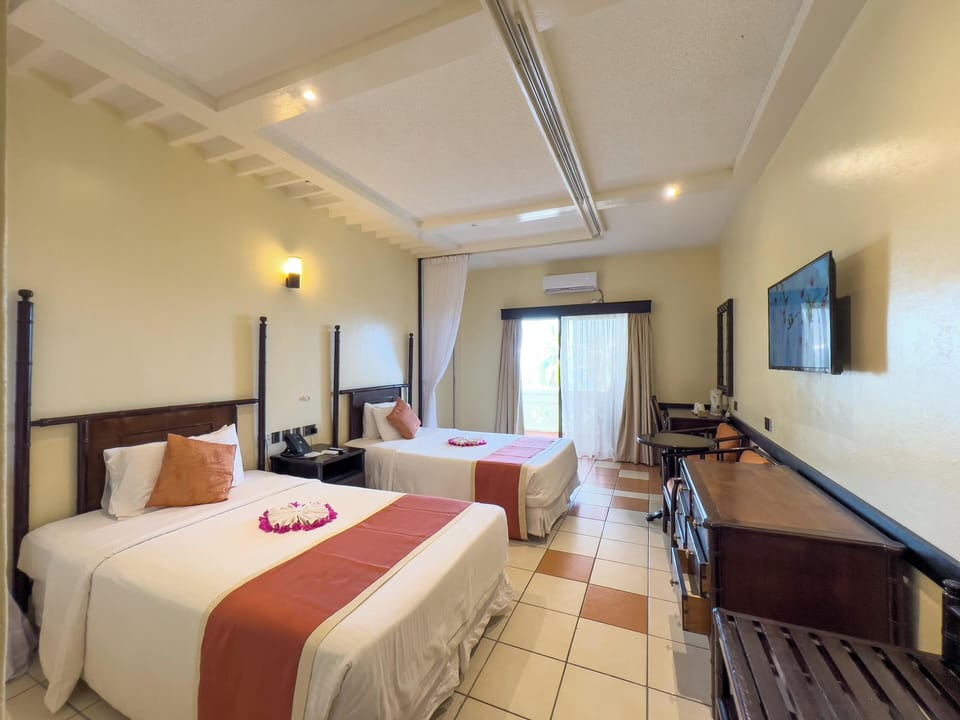 Deluxe Room, Partial Sea View | Premium bedding, memory foam beds, minibar, in-room safe
