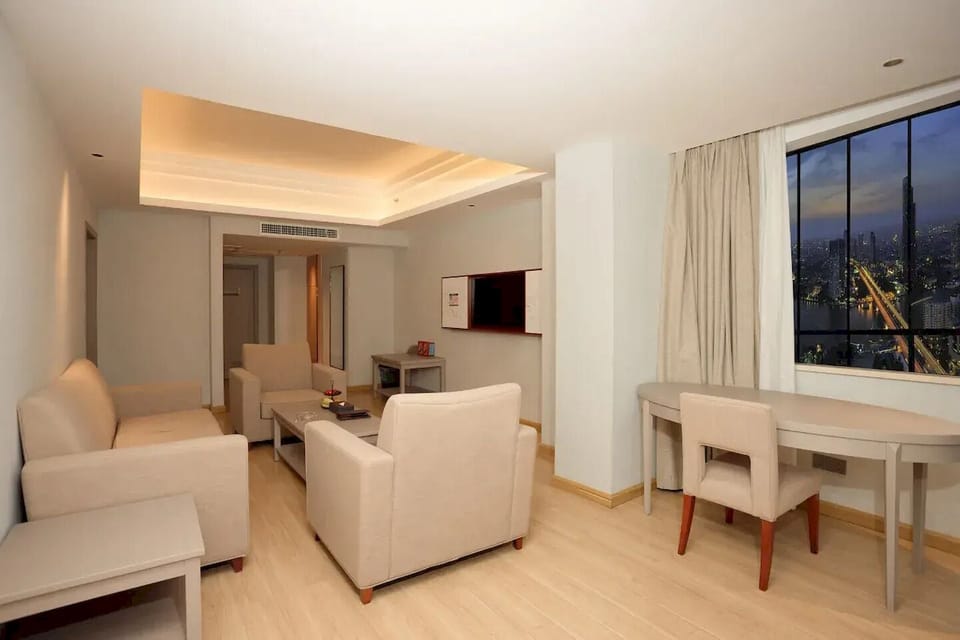 Executive Suite, City View | Living area | 58-inch LED TV with cable channels