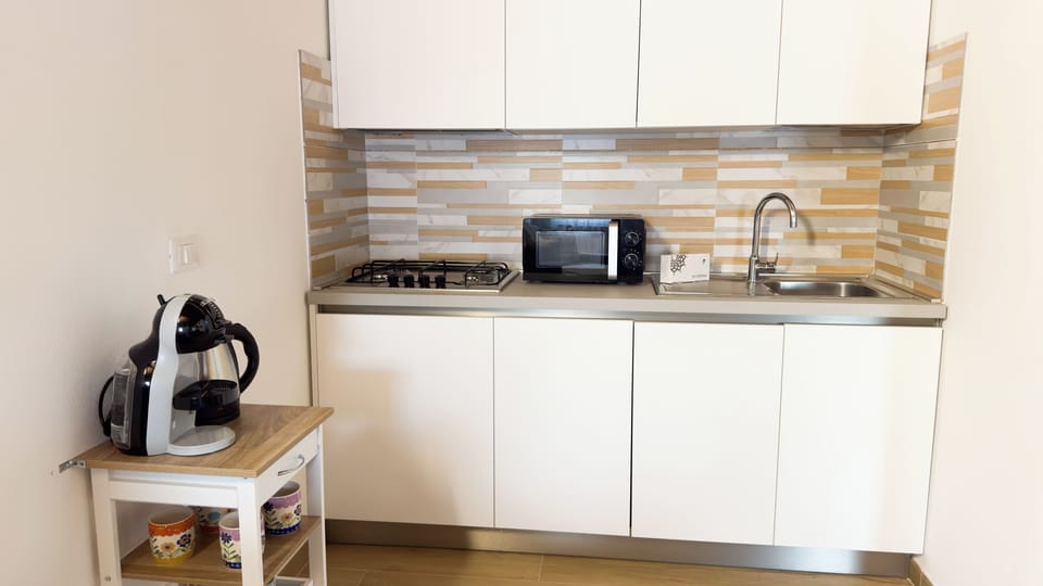 Apartment (1 Bedroom) | Private kitchen | Espresso maker, microwave, stovetop, dishwasher