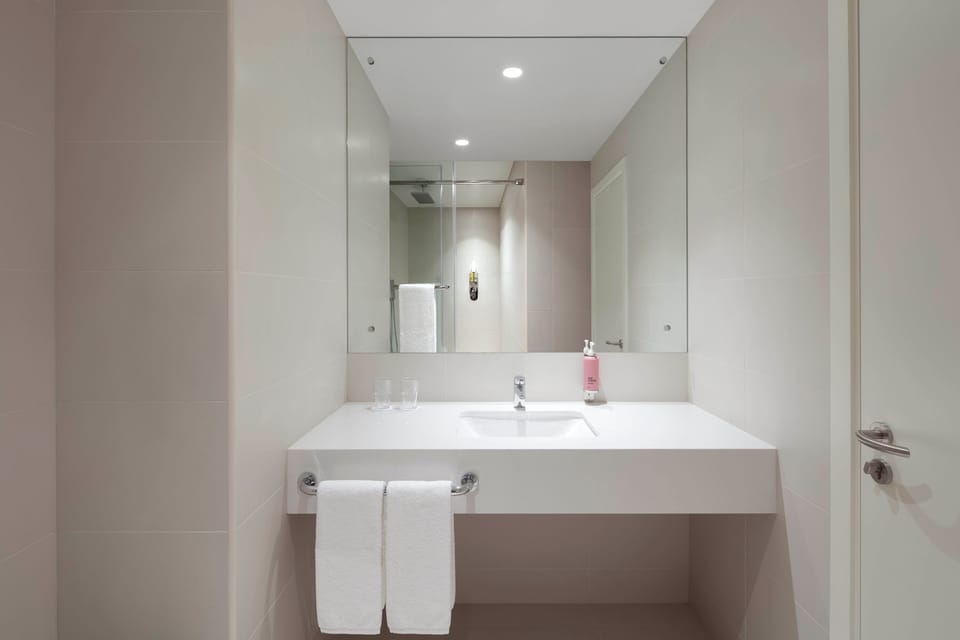 Shower, rainfall showerhead, hair dryer, towels