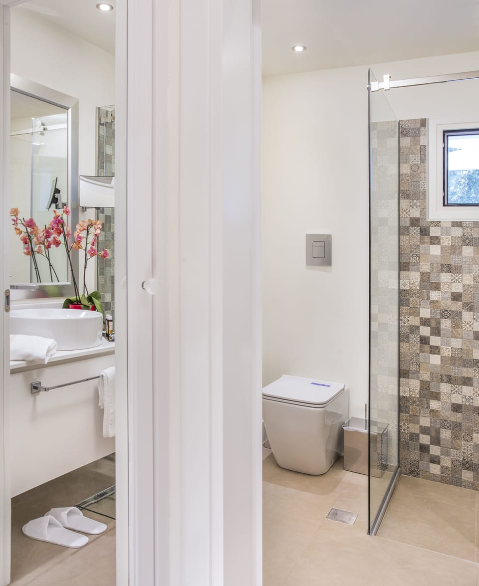 Shower, rainfall showerhead, designer toiletries, hair dryer