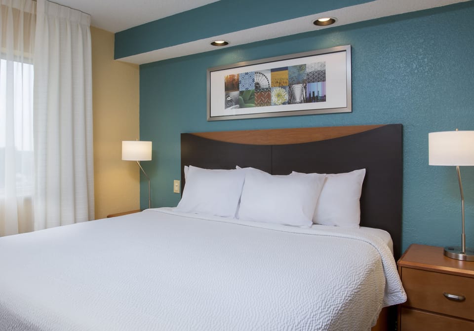 Premium bedding, desk, laptop workspace, blackout drapes