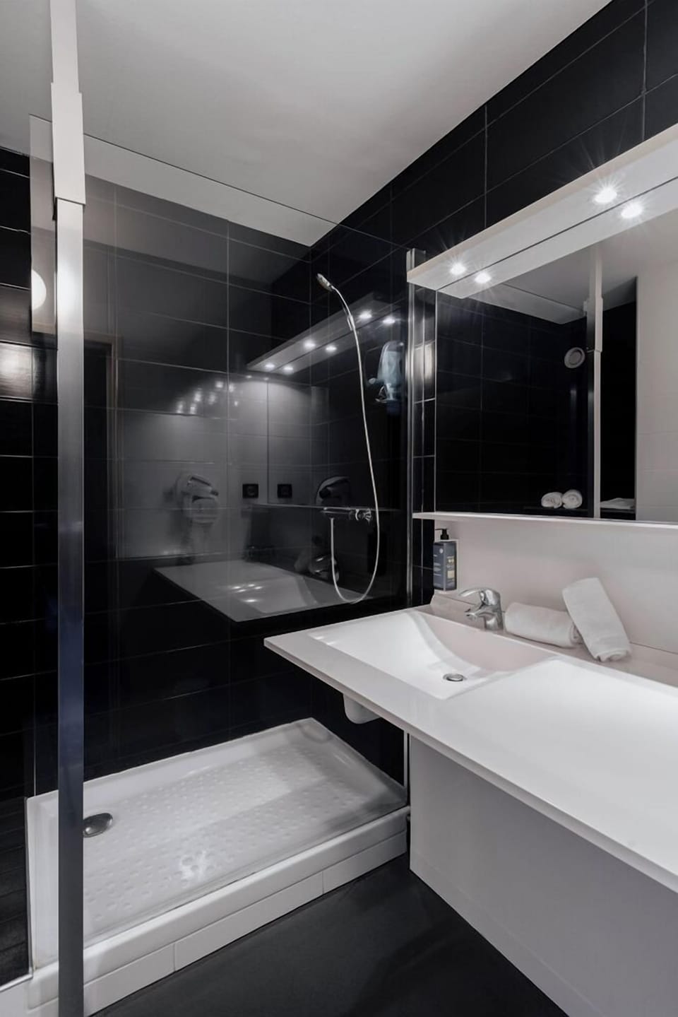 Shower, hair dryer, slippers, towels