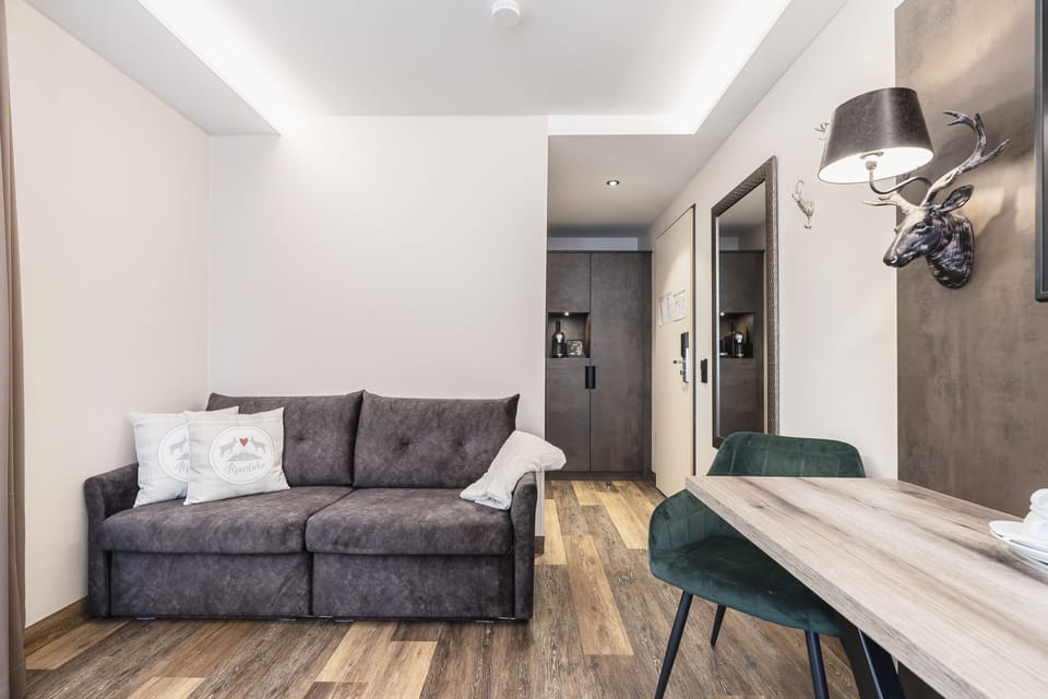 Premium Quadruple Room | Living area | Flat-screen TV