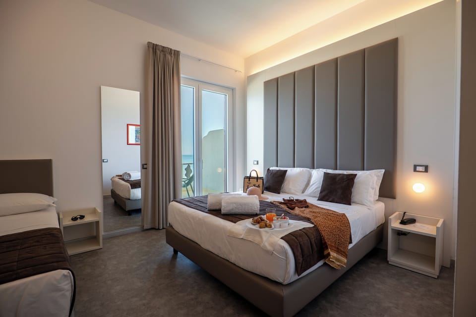 Superior Triple Room, Sea View | Free minibar, in-room safe, individually decorated