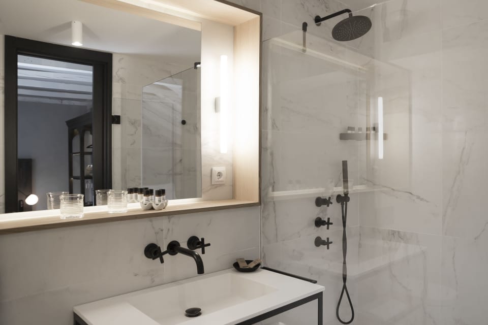 Shower, designer toiletries, hair dryer, slippers