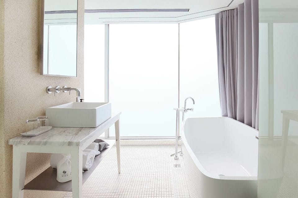 Deluxe Room with Street View | Bathroom | Hair dryer, slippers, towels, shampoo