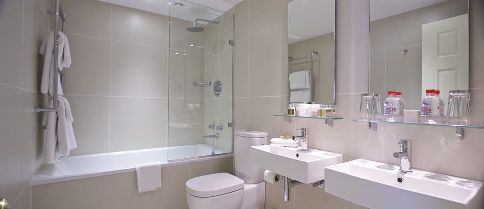 Designer toiletries, hair dryer, towels, toilet paper