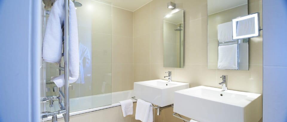 Designer toiletries, hair dryer, towels, toilet paper