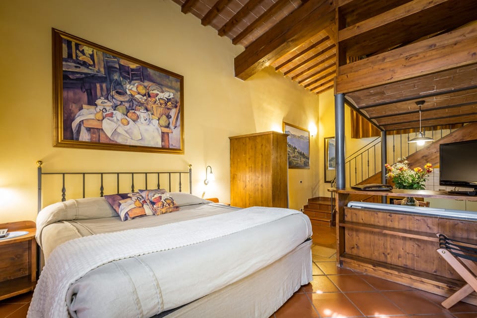 Senior Suite | Minibar, in-room safe, individually decorated, desk
