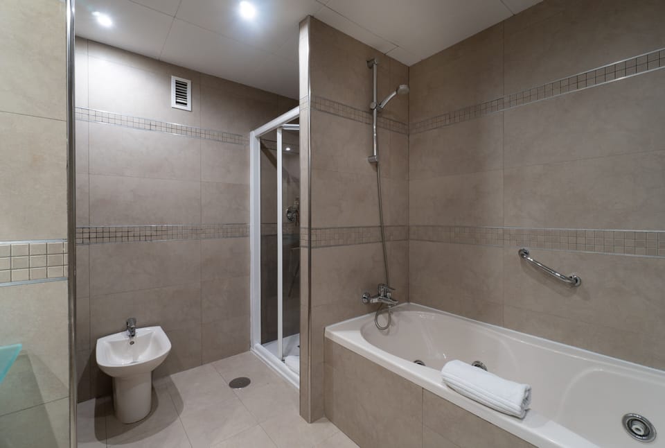 Designer toiletries, hair dryer, bidet, towels