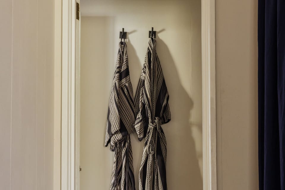 Shower, designer toiletries, hair dryer, bathrobes