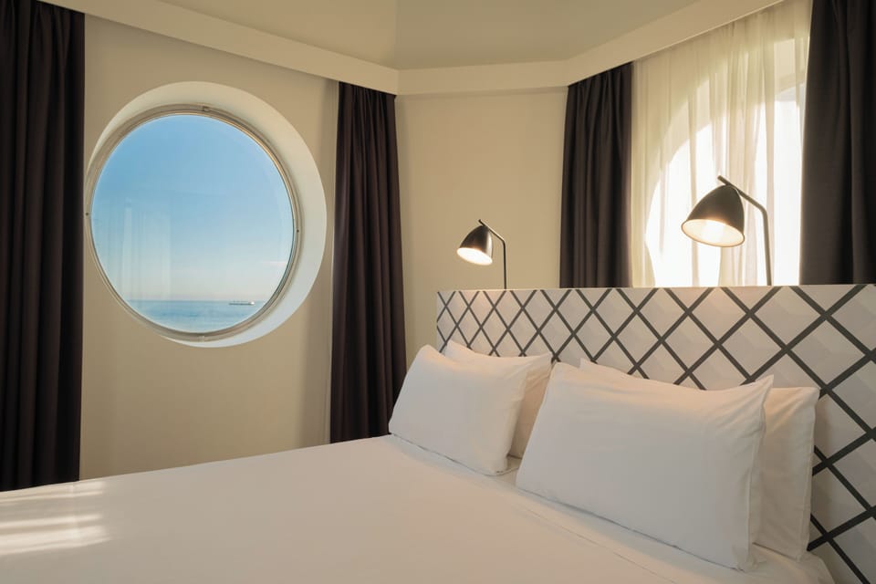 Junior Suite, Sea View | Down comforters, minibar, in-room safe, desk