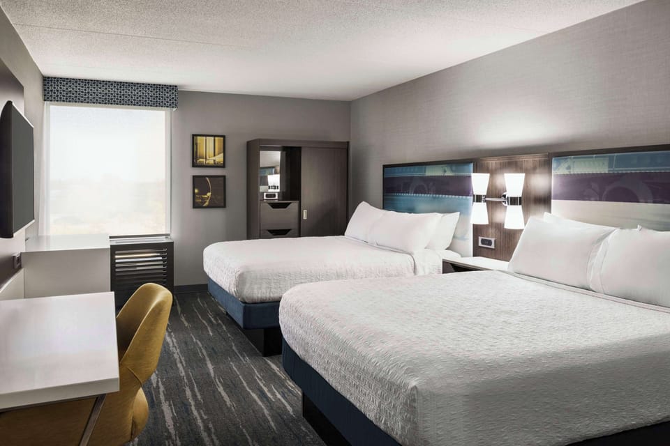 Premium bedding, desk, laptop workspace, blackout drapes