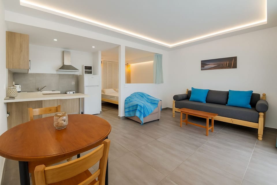 Family Apartment, Pool View, Ground Floor | Living area | 27-inch LCD TV with digital channels