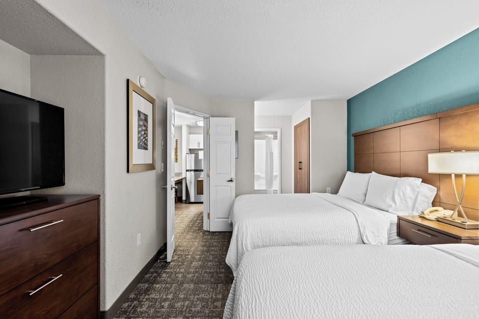 Premium bedding, desk, laptop workspace, blackout drapes