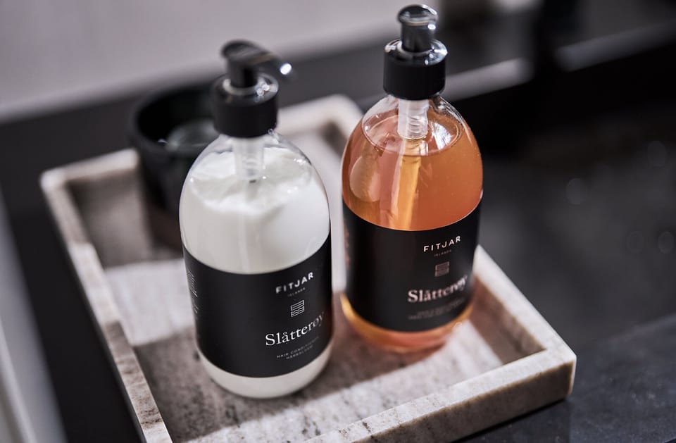 Designer toiletries, hair dryer, towels, toilet paper