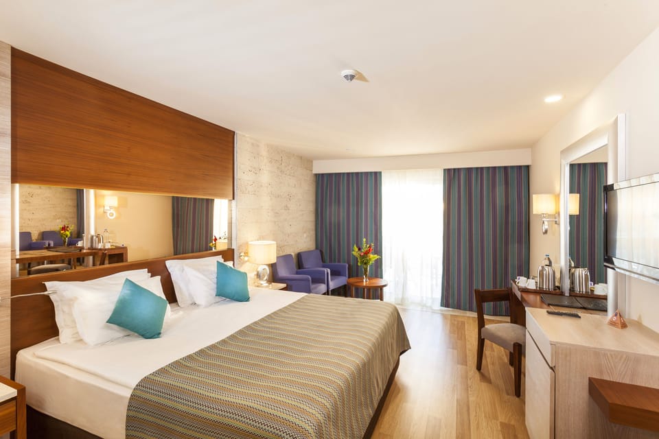 Standard Double Room, Partial Sea View | Minibar, in-room safe, desk, soundproofing