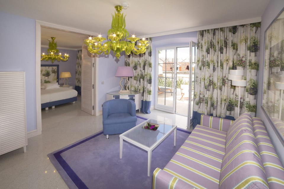 Luxury Suite | Living area | 50-inch flat-screen TV with cable channels, TV, heated floors