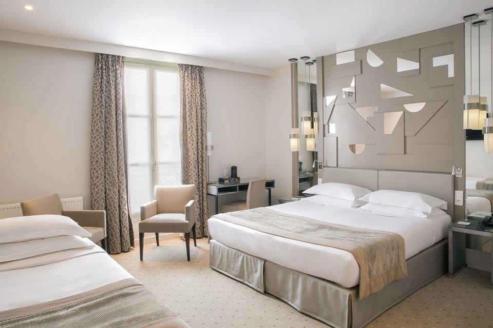 Triple Room | Minibar, in-room safe, individually decorated, desk