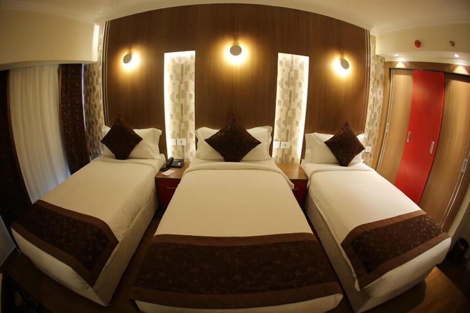Triple Room, City View | Minibar, in-room safe, rollaway beds, free WiFi