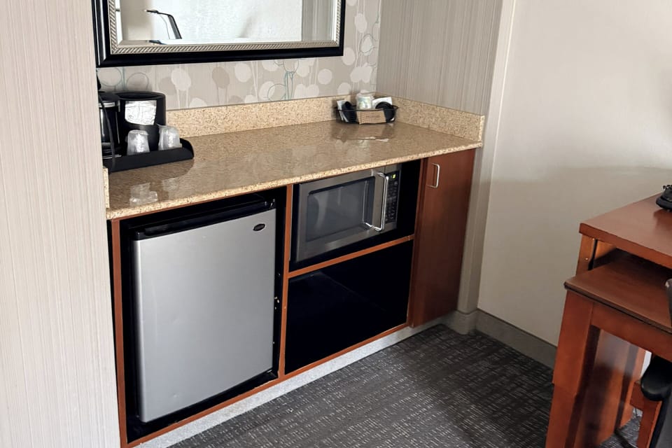 Desk, laptop workspace, blackout drapes, iron/ironing board