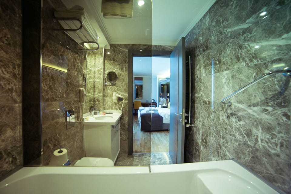 Junior Suite, Jetted Tub | Bathroom | Free toiletries, hair dryer, bathrobes, slippers