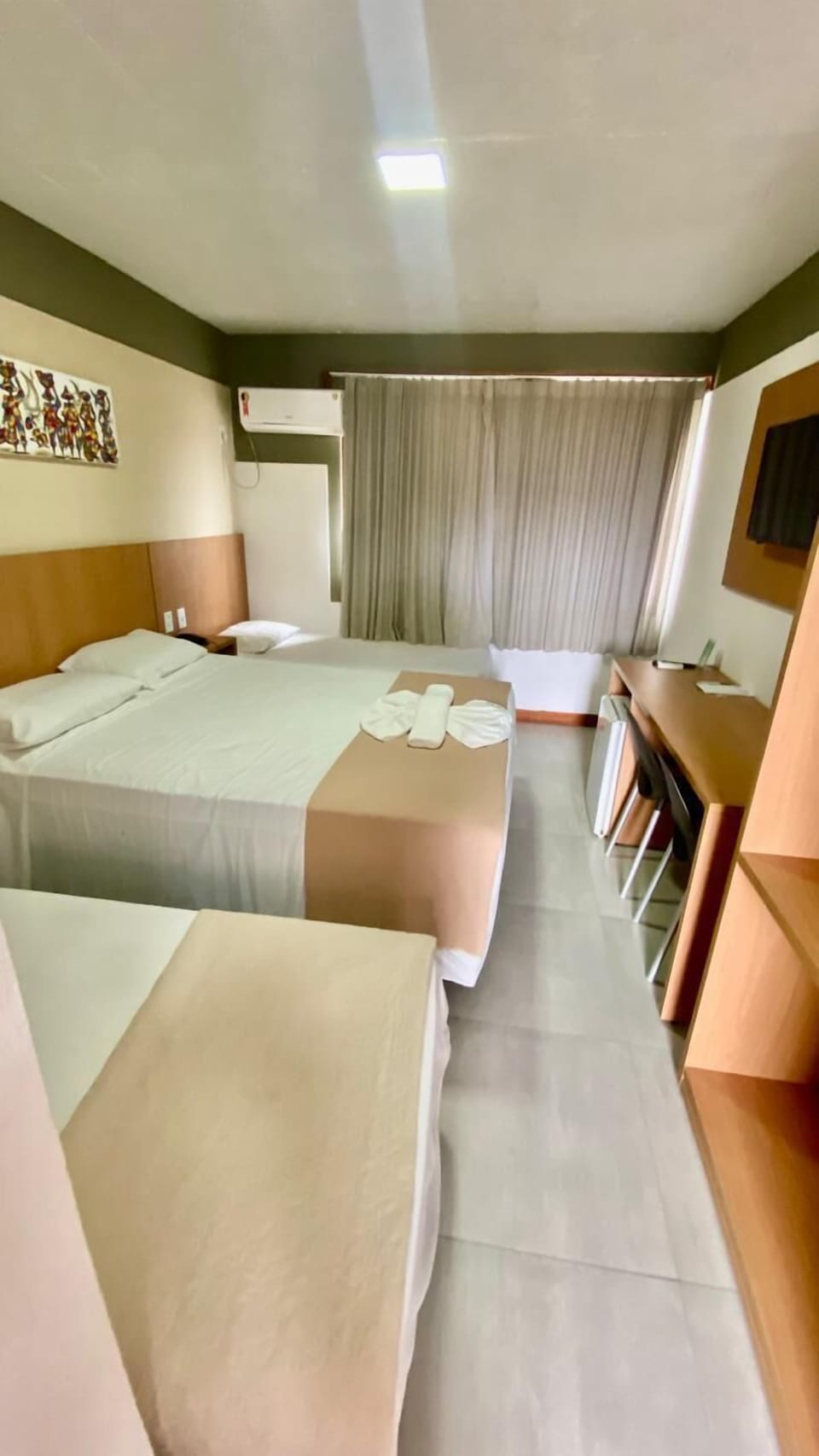 Standard Quadruple Room | Minibar, in-room safe, blackout drapes, iron/ironing board