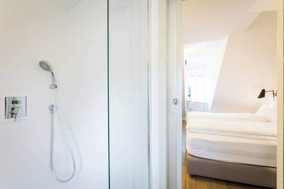 Room in attic, City view | Bathroom | Shower, eco-friendly toiletries, hair dryer, bathrobes