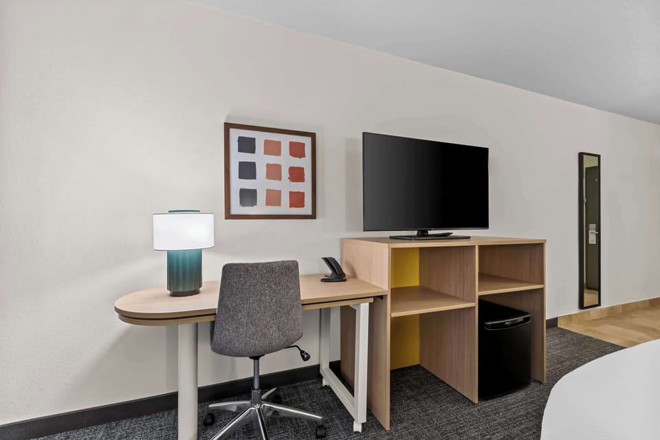 Desk, laptop workspace, blackout drapes, iron/ironing board