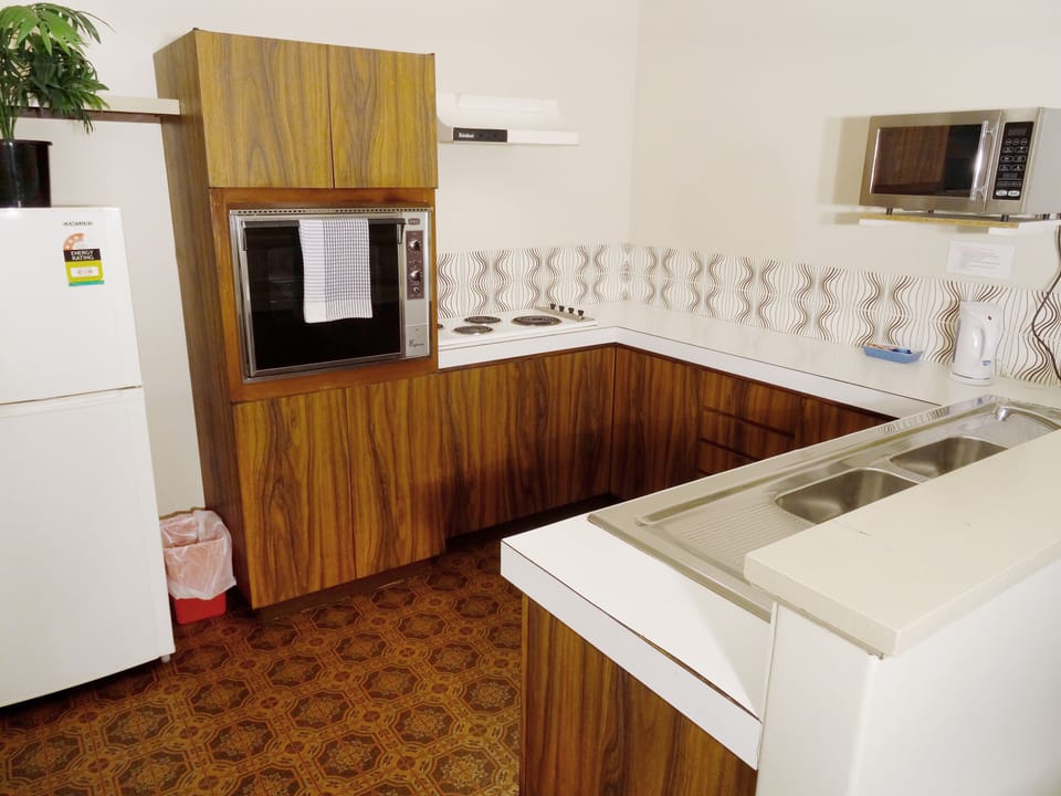 Premier Family Apartment, 2 Bedrooms (1 Queen, 1 Tri-bunk and 1 Sofa bed) | Private kitchen | Full-size fridge, microwave, oven, stovetop